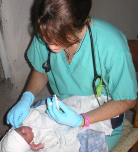 Shelly assisting a baby in the mountains of Haiti, 2006