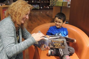 When Reji has book signings and events, she makes sure each child gets some one-on-one reading time with her. She and this young boy from Chicago enjoyed "Max Explores Chicago" together at Barbara's Bestsellers in December 2014.