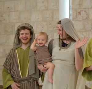 Ariel, Shayla, and daughter Anayah playing Boaz, Ruth, and Obed in an outreach event with 120 non-believing Jewish people present.