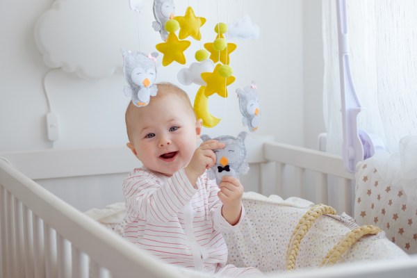 a-laughing-baby-sitting-in-a-crib-and-playing-with-2021-11-15-17-02-01-utc